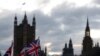 FILE - The sun sets behind the Houses of Parliament in London, Nov. 5, 2019.