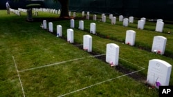 FILE - Headstones are seen at the cemetery of the U.S. Army's Carlisle Barracks, Friday, June 10, 2022, in Carlisle, Pa. The remains of nine more Native American children who died at a government-run boarding school were disinterred and returned to families, authorities said.