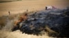 Israeli firefighters attempt to extinguish fire burning scrubland in area where Palestinians have been causing blazes by flying kites and balloons loaded with flammable materials, July 20m 2018.