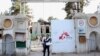 Christopher Stokes, second left, the general director of Doctors Without Borders stands at the gate of its hospital after U.S. troops left the area in Kunduz, Afghanistan, October 15, 2015. 