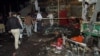 Pakistani police and security officers examine the site of an explosion in Multan, Pakistan, Sunday, Sept. 13, 2015. 