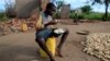 Bernado Jofresse, 14, eats rice for breakfast as he sits beside his family's damaged house in the aftermath of Cyclone Idai, in the village of Cheia, which means "Flood" in Portuguese, near Beira, Mozambique, April 3, 2019.