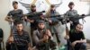 Free Syrian Army fighters pose for a photograph with their weapons in the old city of Aleppo, Sept. 16, 2013.
