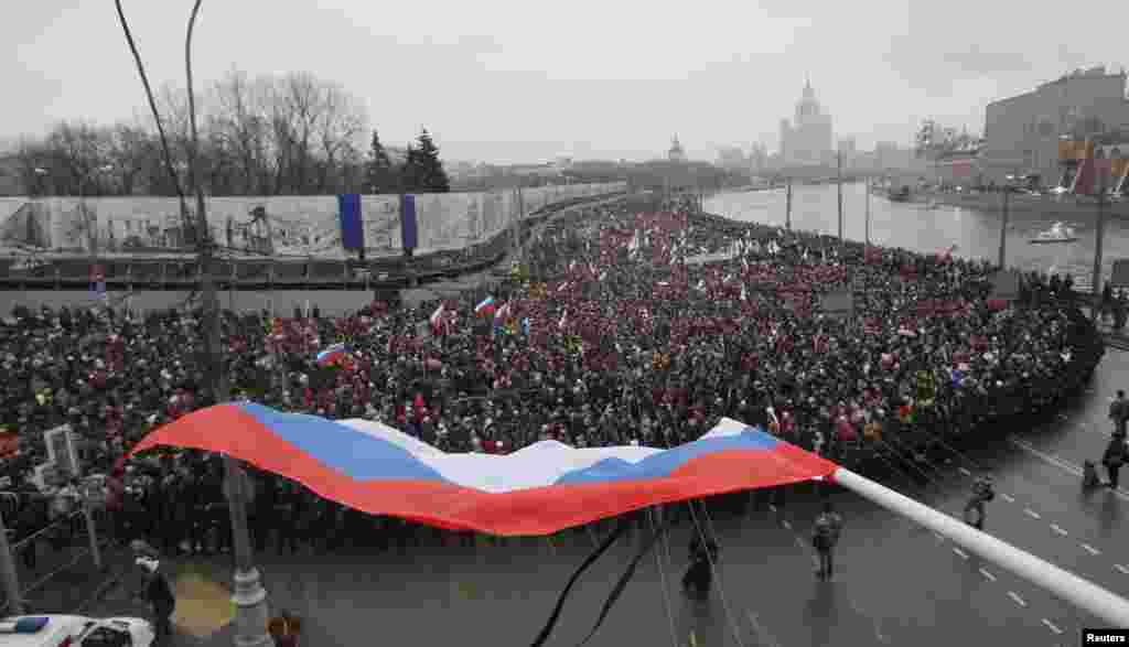 The Russian national flag is pictured during a march to commemorate Kremlin critic Boris Nemtsov, who was shot dead on Friday, in Moscow, March 1, 2015. 