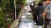 A citizen journalism image provided by the Local Committee of Arbeen which has been authenticated based on contents and AP reporting, shows Syrian citizens trying to identify dead bodies, after an alleged poison gas attack by government forces. 