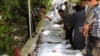A citizen journalism image provided by the Local Committee of Arbeen which has been authenticated based on contents and AP reporting, shows Syrian citizens trying to identify dead bodies, after an alleged poison gas attack by government forces. There has 