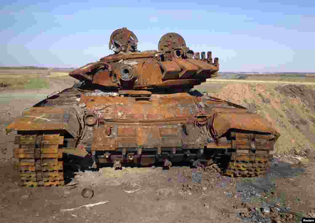 A destroyed Russian-made T-72 tank is seen on a battlefield near separatist-controlled Starobesheve, eastern Ukraine, Oct. 2, 2014.