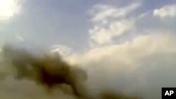 This image taken from video obtained from the Shaam News Network purports to show smoke rising from buildings following a huge explosion in Saadallah al-Jabri Square in Aleppo, Syria, October 3, 2012. 
