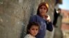 Two Palestinian refugee children lean on the wall of a house in Gezirat al-Fadel village, Sharqiya, about 150 kilometers (93 miles) east of Cairo, Egypt, May 17, 2013.