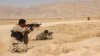 Afghanistan's security forces take their position during a clash by Taliban fighters in the highway between Balkh province to Kunduz city, north of Kabul, Afghanistan, Sept. 1, 2015. 