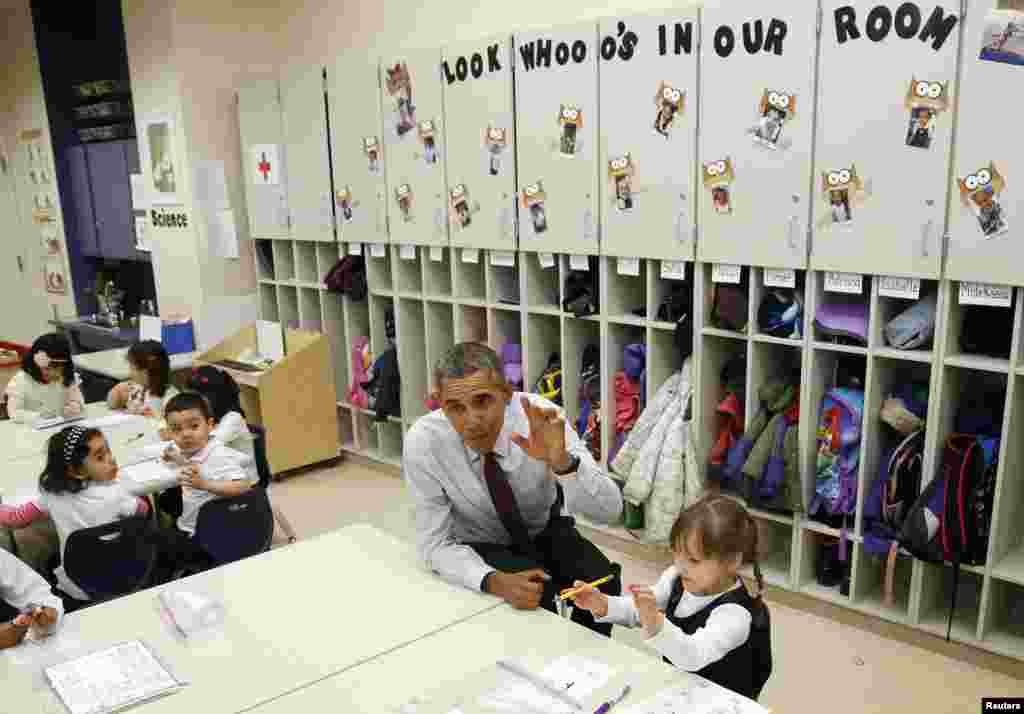 U.S. President Barack Obama sits with Emily Hare as he visits 3- and 4-year olds in a pre-kindergarten class at Powell Elementary School in Washington, D.C.