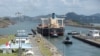 FILE - Cargo vessels transit through the Panama Canal, on the outskirts of Panama City on April 19, 2023.