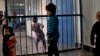 FILE - Children walking through the prison in Badam Bagh, Afghanistan's central women's prison, in Kabul.