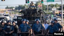 Missuri shtatining Ferguson shaharchasida, 13-avgust, 2014. Politsiyaga qarshi bosh ko'targan ommaga qarshi maxsus kuchlar safarbar etildi. 