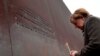 German Chancellor Angela Merkel places a candle at the Berlin Wall Memorial during the central commemoration ceremony for the 30th anniversary of the fall of the Berlin Wall, on Nov. 9, 2019 at the Berlin Wall Memorial at Bernauer Strasse in Berlin.