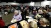 Evacuees from city's surrounding the Oroville Dam line up for dinner at a shelter, Feb. 13, 2017, in Chico, Calif. 