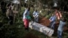 FILE - Health workers prepare to bury a coffin containing a victim of the ebola virus on May 16, 2019 in Butembo, DRC.