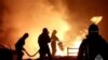 In this image made from video provided by the Russian Emergency Situations Ministry press service, firefighters work to extinguish a fire at a petrol station on a road near Makhachkala, the capital of Dagestan, Russia, on Aug. 14, 2023