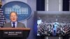 Press Secretary Sean Spicer delivers a statement while television screen show a picture of U.S. President Donald Trump's inauguration at the press briefing room of the White House in Washington, Jan. 21, 2017. 
