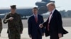 President Donald Trump passes Joint Chiefs Chairman Gen. Joseph Dunford, left, and National Security Adviser Michael Flynn as he arrives via Air Force One at MacDill Air Force Base in Tampa, Fla.