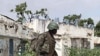 A Ugandan African Union peacekeeper patrols an empty street in the Wardigley district of southern Mogadishu, August 7, 2011
